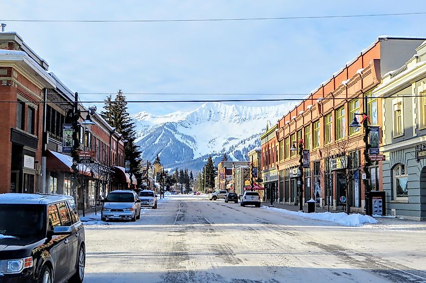 A vibrant street in Fernie, British Columbia with a view of the Rocky Mountains in the backdrop.