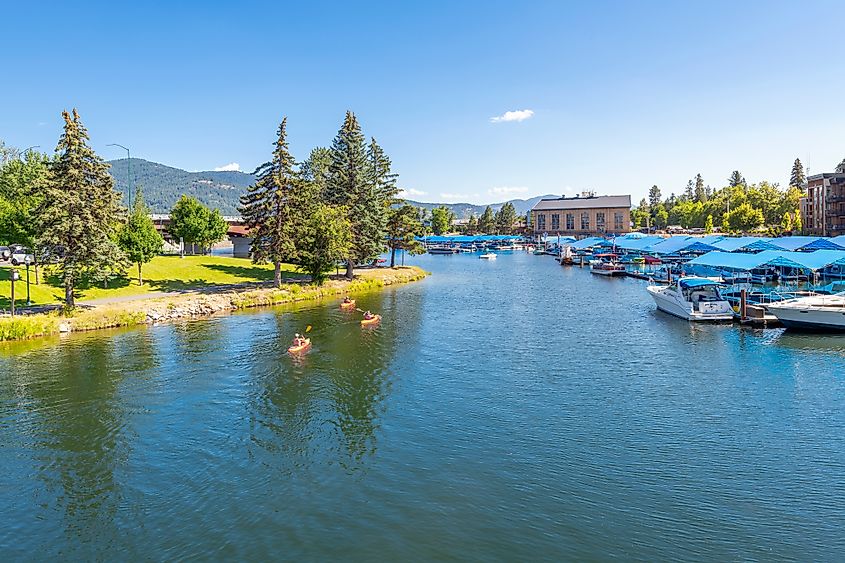 Sandpoint, Idaho - July 23 2022: Kayakers enjoy a sunny summer day on Sand Creek alongside the marina and downtown at Lake Pend Oreille in Sandpoint, Idaho.