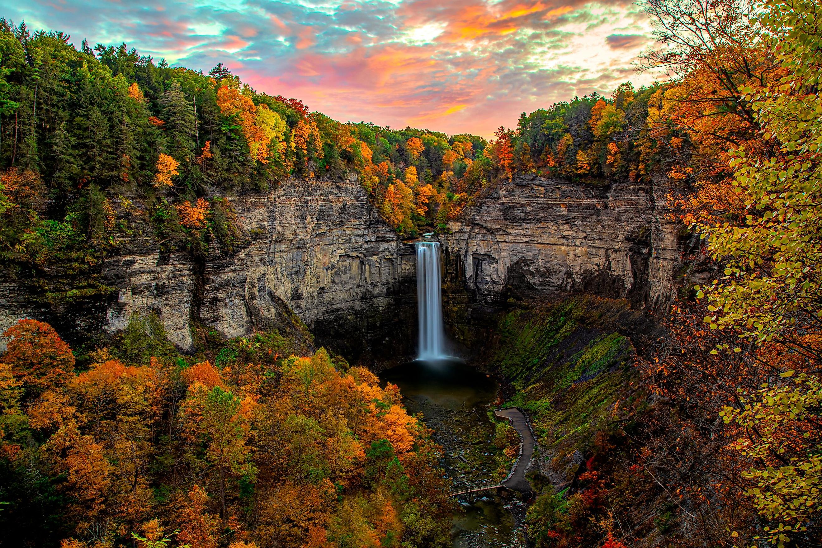 Sunset at Taughannock Falls amidst full fall colors.