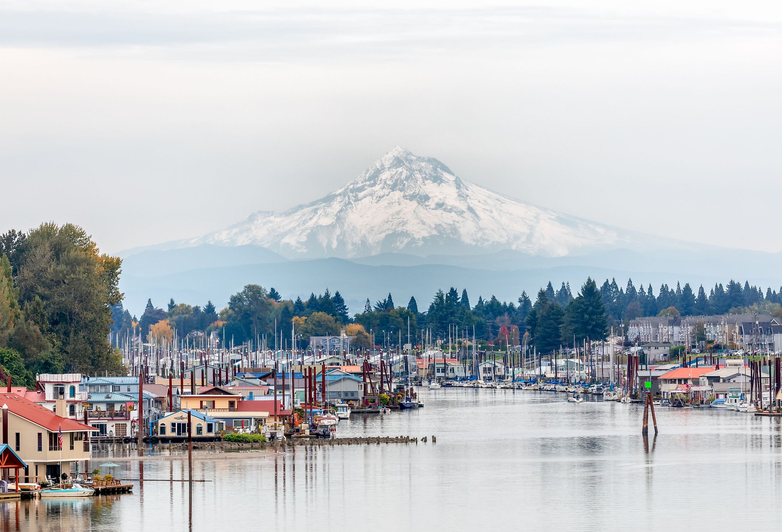 View of Mt. Hood and Portland Marina floating boat houses in Oregon. Image credit Paula Cobleigh via Shutterstock.