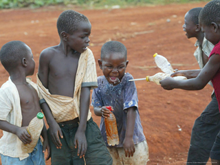 Children Play with Water Near a Zimbabwean Movement for Democratic Change (MDC) Election Rally