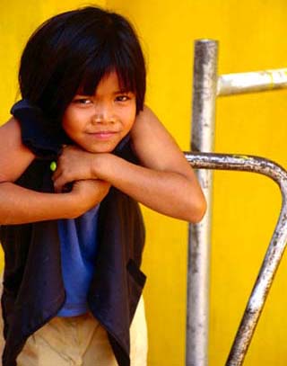 Portrait of Lao Girl at Entrance to Wat St. Muang, Vientiane, Vientiane Prefecture, Laos