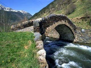 Ancient Stone Bridge over a River in the La Malana District in the Pyrenees in Andorra, Europe