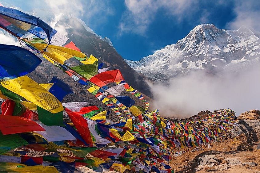 Colorful Tibetan prayer flags line the base of the world's deadliest mountain: Annapurna 
