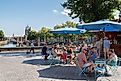 People enjoy the nice weather on the terrace along the harbor in the historic city of Zierikzee, via Wolf-photography / Shutterstock.com