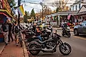 Main Street in New Hope, Pennsylvania, bustling with activity as exotic motorcycles and cars cruise by, highlighting the town's popularity as a travel destination. Editorial credit: JWCohen / Shutterstock.com