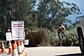 Closed regulation sign posted beside orange cones at a trail access point.