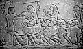 Kushite prisoners of war watched over by Egyptians, waiting to be deported into Egypt. 