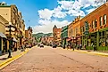 the charming downtown area of Deadwood, South Dakota, with boutique stores and restaurants. Image credit: Kirk Fisher / Shutterstock.com.