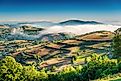 The rolling green landscape of Galicia with its characteristic low-lying clouds.