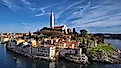 Scenic view of Rovinj old town with colorful houses and Church of St. Euphemia overlooking Adriatic Sea in Croatia.