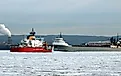 US Coast Guard ship and a grey cargo freighter near the Soo Locks. Editorial credit: T-I / Shutterstock.com