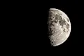 The first quarter moon reveals a hint of its "dark side."  Via Shutterstock / Jordon Sharp