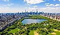  Aerial view of the Central park in New York with golf fields and tall skyscrapers surrounding the park.