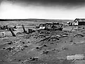 Buried machinery in a barn lot; Dallas, South Dakota, May 1936