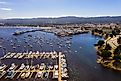 Aerial view of the Monterey Bay Aquarium, Pacific Grove with many yachts docked by the coastline in Monterey, central California.