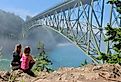 Group of women by ocean in foggy morning in Deception Pass Bridge Park, Anacortes, Washington.