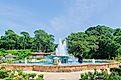 People sitting by the fountain at the Fairhope Municipal Pier in Fairhope, Alabama.