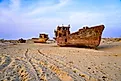 Rusty shipwreck lying on the seabed of the dried-up Aral Sea in Moynaq (or Muynak), a former fishing town in Karakalpakstan, Uzbekistan