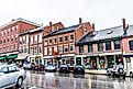 Brick buildings lined along the steep main street in Belfast, Maine. Image credit Kristi Blokhin via Shutterstock