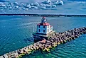 A drone shot of the Ashtabula Harbor Light building under a cloudy sky in Ohio, USA