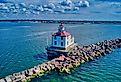 A drone shot of the Ashtabula Harbor Light building under a cloudy sky in Ohio, USA