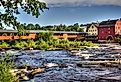 The River Walk Covered Bridge with the Grist mill on the Ammonoosuc River in Littleton, New Hampshire.