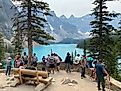 A crowded lookout above the Moraine Lake in Banff National Park. Its bright blue waters and surrounding Rocky Mountain peaks always draws summer crowds.