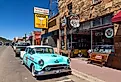 Street scene with classic car in front of souvenir shops in Williams, one of the cities on the famous route 66. Image credit Jordi C via Shutterstock.