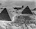 American Air Transport Command plane flies over the pyramids of Egypt. 