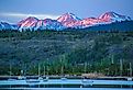 Alpenglow hitting the peaks of Grays and Torreys beyond the Frisco Bay Marina in Frisco, Colorado. Image credit Joey Reuteman via Shutterstock.