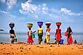 Women with their laundry at Lake Tanganyika, TanzaniaEditorial credit: Yury Birukov / Shutterstock.com