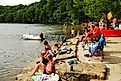 People enjoying their leisure time by the beautiful Walden Pond in Concord, Massachusetts.