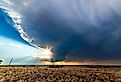 Large, powerful tornadic supercell storm moving over the Great Plains during sunset, setting the stage for the formation of tornados across Tornado Alley.