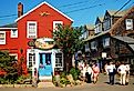 Folks stroll around the unique shops and boutiques on Bearskin Neck in Rockport, Massachusetts. Image credit James Kirkikis via Shutterstock