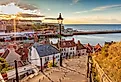 Famous 199 steps at sunset over the harbour at Whitby, England, UK. Image credit cally robin via Shutterstock