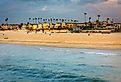 Waves in the Pacific Ocean and view of the beach at sunset in Seal Beach, California.