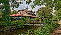 Small wooden bridge crossing the Delaware River Canal with reflections in Lambertville, New Jersey.