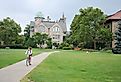 An Oberlin student rides her bicycle through the main quad in front of Peters Hall at Oberlin College. Image credit PICTOR PICTURES via Shutterstock