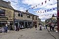 This is historic Haworth, Yorkshire, England, UK, home of the Bronte sisters. The village is bedecked in bunting and union flags as it celebrates the Platinum Jubilee of Queen Elizabeth II.