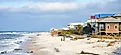 Siesta Key Beach in Sarasota, Florida, on a beautiful sunny day during spring break, with bright blue water, boats, and white sands.