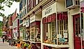 Shops, eateries, and baseball-themed attractions line the sidewalk on Main Street in Cooperstown, New York. Editorial credit: Kenneth Sponsler / Shutterstock.com