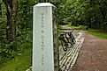 Two bikes are parked by a concrete marker indicating the location where the Great Allegheny Passage crosses the Mason Dixon Line near Frostburg, PA. Editorial credit: Dave Jonasen / Shutterstock.com