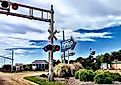 Business District sign and railroad crossing in Tupelo, Mississipi. Via Shutterstock / Lucideye-James Walker.