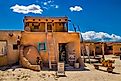 Tourists visit the historic Taos Pueblo near Taos, New Mexico. Image credit Sean Pavone via Shutterstock.com