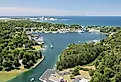 Aerial view of Round Lake in Charlevoix, Michigan, early summer, with boat traffic.