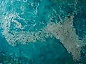 Ocean water and plastic trash island. Aerial view of pollution by plastic rubbish