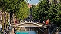 Summer cityscape with architecture traditional canal houses, 3D-printed steel bridge, Red light district, Stoofsteeg, Oudezijds Achterburgwal, Holland, via Wut_Moppie / Shutterstock.com