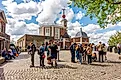 London, UK: Tourists standing on Greenwich meridian in Royal Observatory