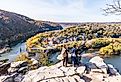 Overlook with hikers, colorful orange and yellow fall foliage overlooking Harper's Ferry, West Virginia. Image credit Andriy Blokhin via Shutterstock